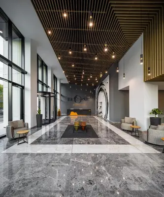 a lobby with couches and a table in the middle at B1 City Hotel Sofia in Sofia
