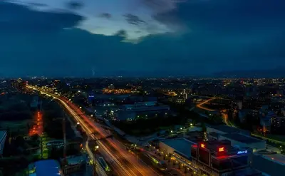 a city lit up at night with traffic at B1 City Hotel Sofia in Sofia