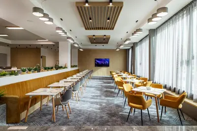 a row of tables and chairs in a restaurant at B1 City Hotel Sofia in Sofia