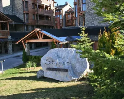 a sign on a rock in front of a building at Best Mountain View Chalet in Bansko