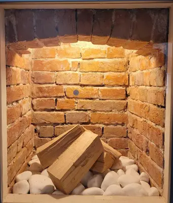 a brick wall with a wooden bench on a pile of mushrooms at The House - Central Boutique Apartments in Kyustendil