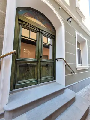 a green door on the side of a building at The House - Central Boutique Apartments in Kyustendil