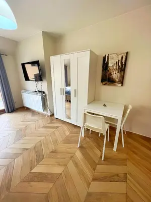 a room with a desk and a table and a chair at Azurro Residence in Sofia