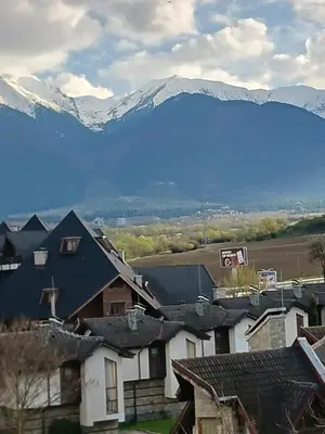 a view of a village with mountains in the background at Аспен валей С420 in Razlog