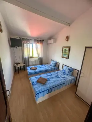 two beds in a small room with a television at ТРАКАРТ-ПАРК in Plovdiv