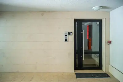 an elevator door in a room with a wall at Bright Studio in the City Center in Sofia