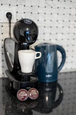 a coffee maker and a cup on a counter at Bright Studio in the City Center in Sofia