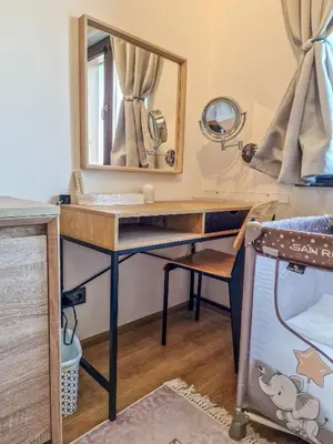 a dressing room with a desk and a mirror at Pastels - 2BD in Trinity Bansko with underground parking by Flat Mаnager in Bansko