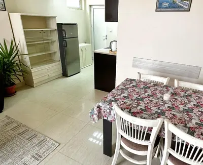 a kitchen with a table and a refrigerator at Diana’s place in Sandanski