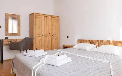 a bedroom with two beds with white towels on them at Къща за гости Константин и Елена - гр. Девин in Devin