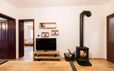 a living room with a television and a fireplace at Къща за гости Константин и Елена - гр. Девин in Devin