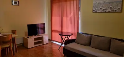 a living room with a couch and a flat screen tv at Bojurland, Bansko, Bulgaria in Bansko