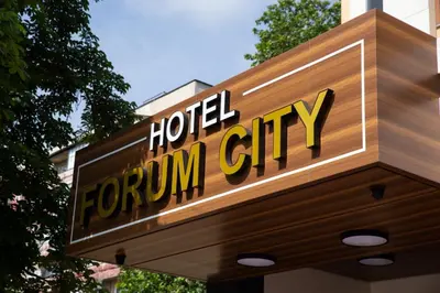 a sign for a hotel for a downtown city at Hotel Forum City in Pazardzhik