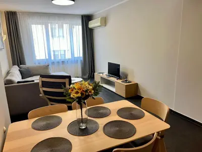a living room with a table with a vase of flowers on it at EXCELLENT LOCATION ! General Gurko apartment in Sofia