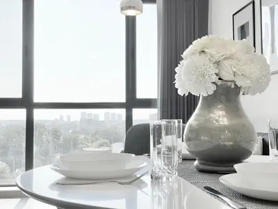 a table with a vase with white flowers on it at Private Apartment for 4 Guests and Parking in Plovdiv