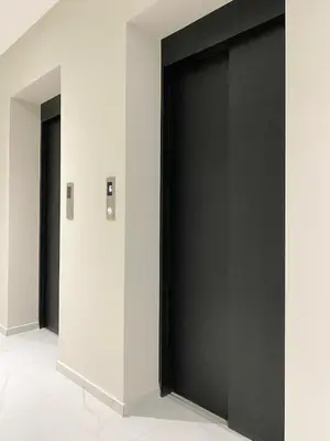 two black doors in a room with white walls at Private Apartment for 4 Guests and Parking in Plovdiv