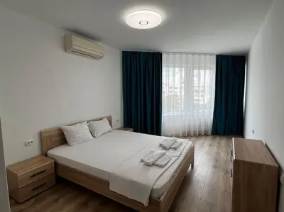 a bedroom with a large bed and a window at Blue & Gold Stylish Apartment in Sofia