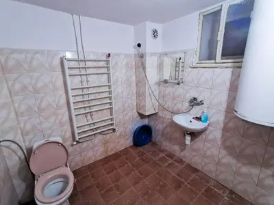 a bathroom with a toilet and a sink at Комплекс Петлето in Smolyan