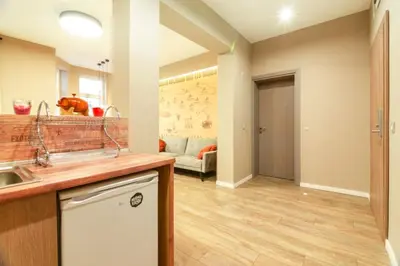 a kitchen with a sink and a living room at 1 BR Wine Journey in Sofia