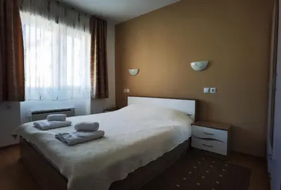 a bedroom with a bed with two towels on it at Апартамент 204 Студенец in Pamporovo