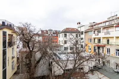 a group of buildings in a city with a tree at Viral 2 BR Photo Studio Loft in Sofia