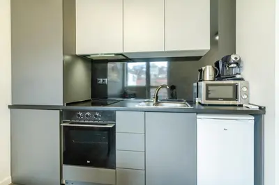 a kitchen with a stove and a microwave at Viral 2 BR Photo Studio Loft in Sofia