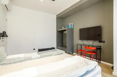 a bedroom with two beds and a flat screen tv at Viral 2 BR Photo Studio Loft in Sofia