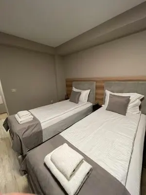 two beds sitting next to each other in a room at Hotel BLISS Sofia Airport Self Check In in Kazichene