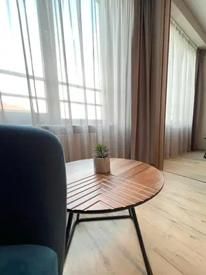 a table with a plant on it in a room at Hotel BLISS Sofia Airport Self Check In in Kazichene