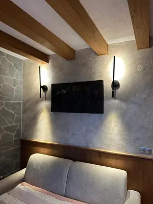 a living room with a couch and a painting on the wall at Pirin Golf Hotel&Spa Apartment 17 - private luxury apartment in Razlog