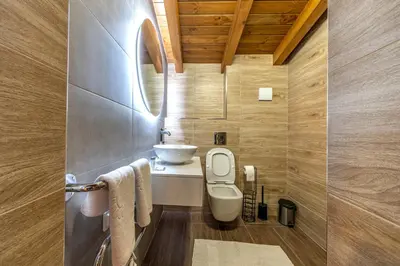 a bathroom with a white toilet and a sink at Pirin Golf Hotel&Spa Apartment 17 - private luxury apartment in Razlog
