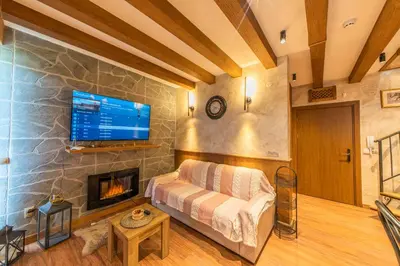 a living room with a couch and a fireplace at Pirin Golf Hotel&Spa Apartment 17 - private luxury apartment in Razlog