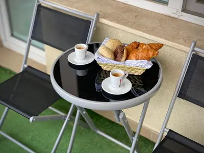 a table with croissants and cups of coffee and bread at Entire Apartment for 4 Guests in Sofia in Sofia