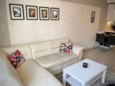 a living room with a white couch and a table at Entire Apartment for 4 Guests in Sofia in Sofia