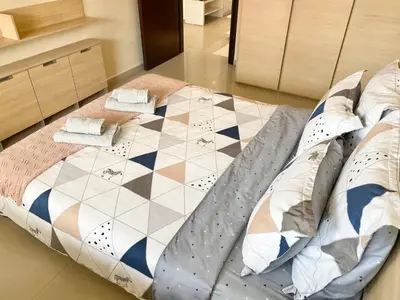 a large bed in a room with a checkerboard pattern at Entire Apartment for 4 Guests in Sofia in Sofia