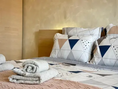 a bedroom with a bed with towels and pillows at Entire Apartment for 4 Guests in Sofia in Sofia