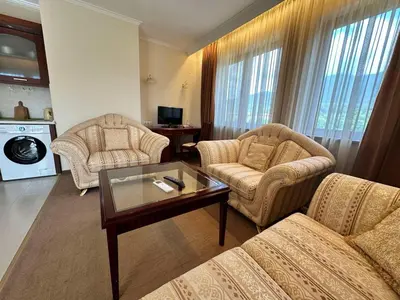 a living room with two chairs and a coffee table at Downtown apartments in Bansko