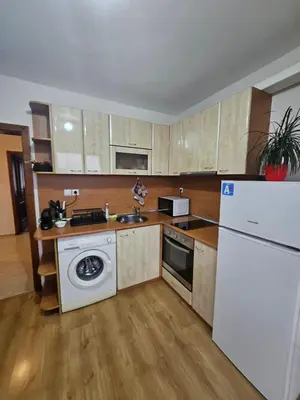 a kitchen with a white refrigerator and a sink at Апартамент Радост in Bansko