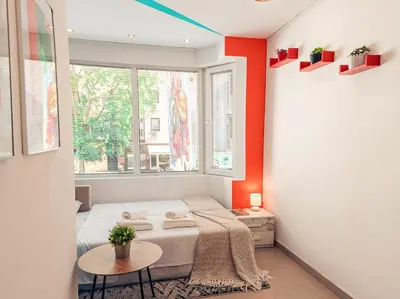 a small room with a bed and a window at BohoBox Studios in Plovdiv
