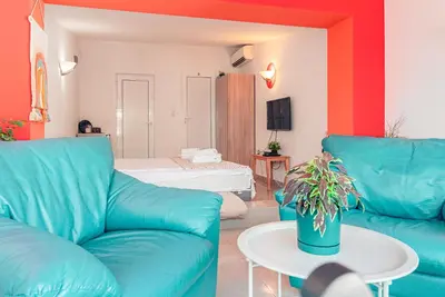 a living room with a blue couch and a table at BohoBox Studios in Plovdiv