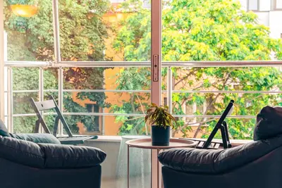 a room with two chairs and a table with a laptop at BohoBox Studios in Plovdiv