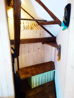 a closet with wooden shelves and a bench in a room at Ethno art maisonette in the center of Sofia - plus Free Vouchers & Gift in Sofia