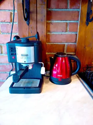 a coffee maker and a red tea kettle on a table at Ethno art maisonette in the center of Sofia - plus Free Vouchers & Gift in Sofia