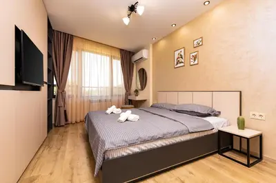 a bedroom with a bed with two towels on it at Urban Lux Apartments Center of Plovdiv by Flat Mаnager in Plovdiv