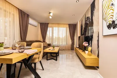 a living room with a dining table and a couch at Urban Lux Apartments Center of Plovdiv by Flat Mаnager in Plovdiv