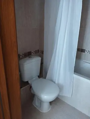 a bathroom with a toilet and a shower curtain at Pirin Golf - NIRVANA, Studio&SPA in Razlog