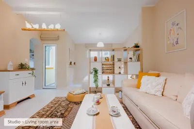 a living room with a couch and a table at Super Central Stylish Suite & Studio with Shared Terrace by Flat Mаnager in Sofia