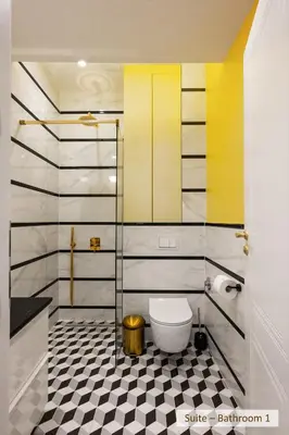 a bathroom with a toilet and a black and white tile floor at Super Central Stylish Suite & Studio with Shared Terrace by Flat Mаnager in Sofia