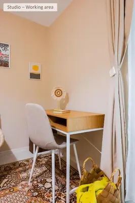 a desk in a room with a chair and a table at Super Central Stylish Suite & Studio with Shared Terrace by Flat Mаnager in Sofia
