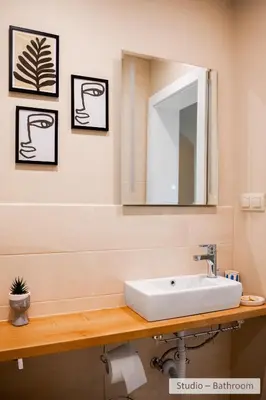a bathroom with a sink and a mirror at Super Central Stylish Suite & Studio with Shared Terrace by Flat Mаnager in Sofia